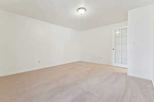 Carpeted spare room featuring a textured ceiling