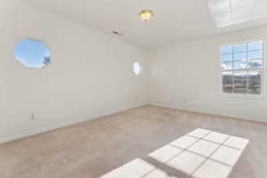 Spare room with light colored carpet