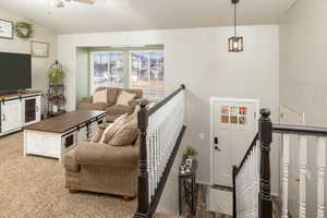 Living room with carpet flooring and lofted ceiling