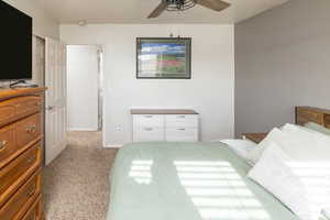 Carpeted bedroom with ceiling fan