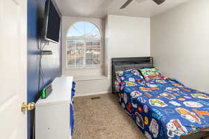 Bedroom with ceiling fan and carpet floors