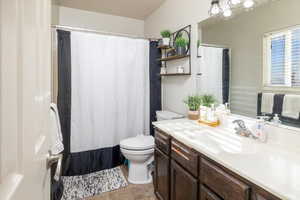 Bathroom with tile patterned floors, vanity, and toilet