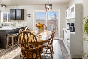 Dining space featuring dark wood-type flooring and sink