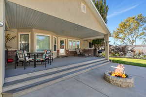 Large backyard entertaining space with firepit