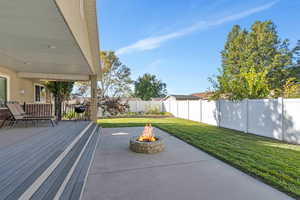 Large backyard entertaining space with firepit