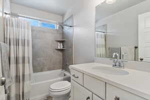 Full bathroom with vanity, toilet, and shower / tub combo