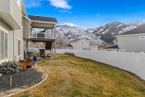 View of yard with a deck with mountain view