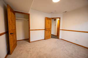 Unfurnished bedroom with a closet and carpet