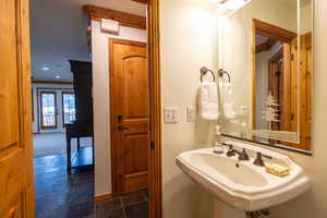 Bathroom with sink, french doors, and ornamental molding