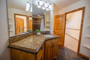 Bathroom with vanity and curtained shower