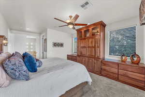 Carpeted bedroom with ceiling fan