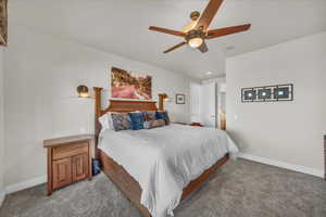 Bedroom featuring ceiling fan and carpet