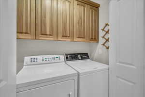 Laundry area with cabinets and independent washer and dryer