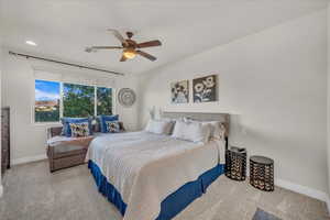 Carpeted bedroom with ceiling fan