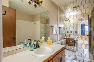 Bathroom featuring a bidet, vanity, a textured ceiling, and toilet