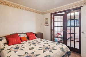 Bedroom with french doors and carpet floors