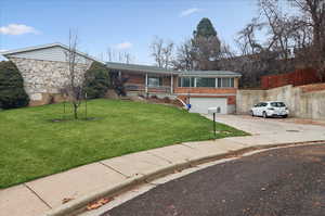 View of front facade with a front yard and a garage