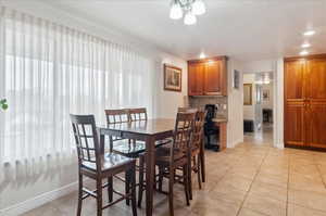 Dining area featuring light tile patterned flooring