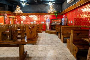 Bar with ceiling fan and tile patterned flooring