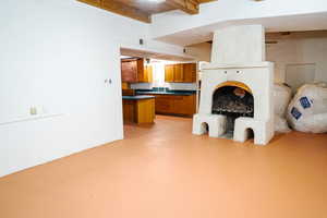 Unfurnished living room with beamed ceiling