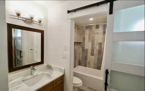 Full bathroom featuring toilet, vanity, and bathing tub / shower combination