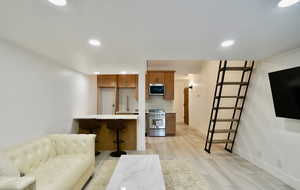 Living room with light hardwood / wood-style floors