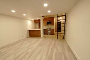 Unfurnished living room featuring light wood-type flooring