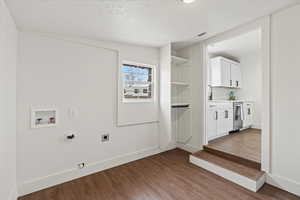 Mud room featuring cabinets, washer hookup, electric dryer hookup, and hardwood / wood-style floors