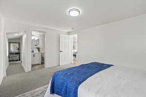 Primary bedroom featuring ensuite bath and walk in closet