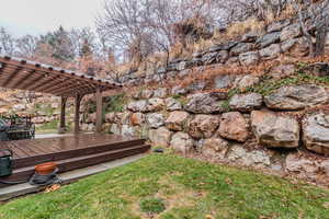 View of yard with a pergola and a wooden deck