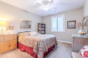 Bedroom featuring carpet flooring and ceiling fan