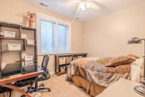 Bedroom featuring ceiling fan and light colored carpet