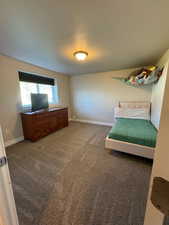 Unfurnished bedroom with carpet flooring and a textured ceiling