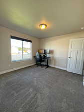 Office featuring dark colored carpet