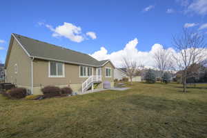 Rear view of house featuring a lawn