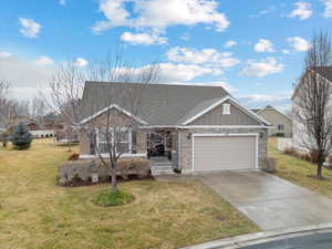 View of front of property with a front yard and a garage