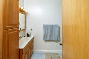 Bathroom with tile patterned flooring and vanity