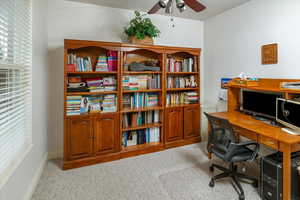 Carpeted office space with ceiling fan could be 6th bedroom