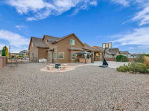 Rear view of house featuring a patio area and an outdoor fire pit