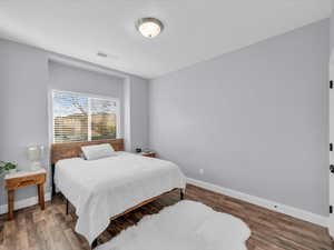 Bedroom with wood-type flooring