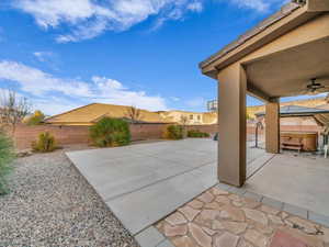 View of patio featuring ceiling fan and a hot tub