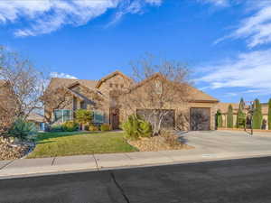 View of front of home featuring a front yard and a garage