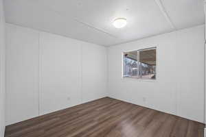 Unfurnished room featuring dark wood-type flooring