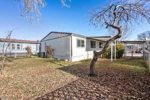 View of home's exterior with a yard and cooling unit