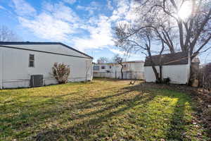 View of yard featuring a storage shed and central air condition unit