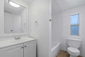 Full bathroom featuring tile patterned flooring, vanity, toilet, and separate shower and tub