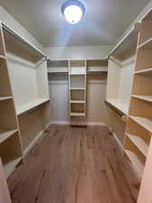 Spacious closet featuring light wood-type flooring