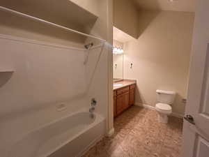 Full bathroom with vanity, bathtub / shower combination, and toilet