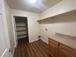 Laundry area featuring hookup for an electric dryer, hookup for a gas dryer, dark wood-type flooring, and washer hookup