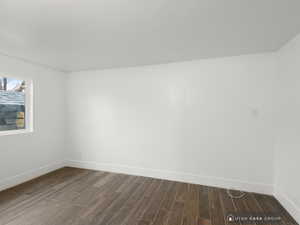 Spare room with dark hardwood / wood-style floors